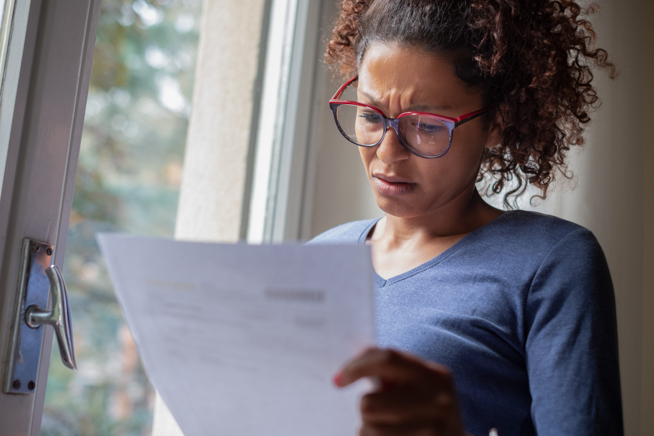 Worried woman reading a letter from the IRS